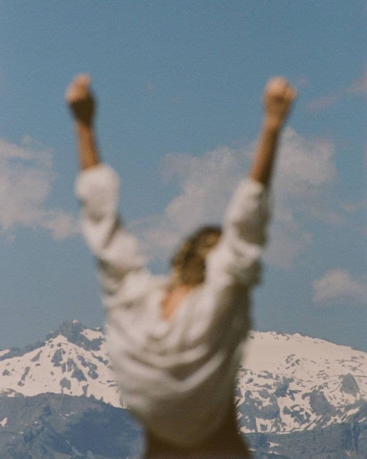 Arms raised against an open sky